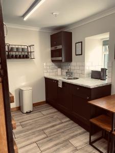 a kitchen with a sink and a counter top at Ben Nevis Inn Rooms in Fort William +24 photos
