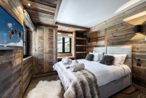 a bedroom with wooden walls and a large bed at Résidence Petit Alaska - 5 Pièces pour 8 Personnes 684 in Val-d'Isère