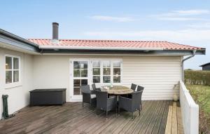 a patio with a table and chairs on a deck at Nice Home In Nyborg With Kitchen in Nyborg