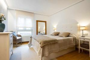 a bedroom with a large bed in a room at Appto Jose Luis Llanes in Llanes