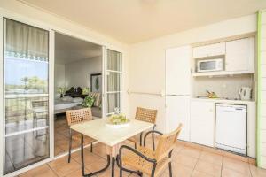 a kitchen and dining room with a table and chairs at Village Sainte Luce, Martinique - maeva Home - Studio 3 personnes - Prestige MAE-8324 in Sainte-Luce
