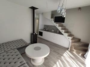 a living room with a toilet and a staircase at Villa Butterfly in Palanga