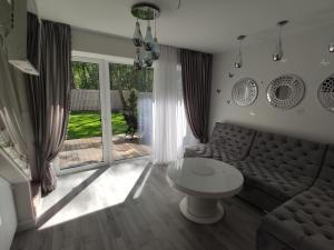 a living room with a couch and a table at Villa Butterfly in Palanga