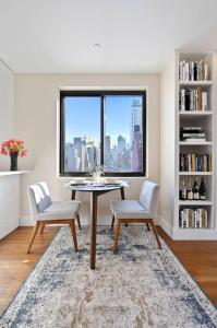 a dining room with a table and two chairs and a window at Modern one bedroom with private balcony in New York