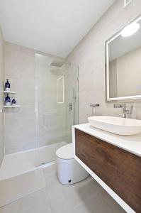 a bathroom with a sink and a toilet and a shower at Modern one bedroom with private balcony in New York