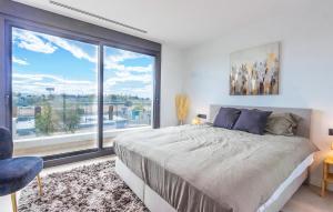 a bedroom with a bed and a large window at 3 Bedroom Amazing Home In Torre Pacheco in Torre-Pacheco