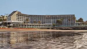 a large building on the beach with the water at Don Gregory by Dunas - Adults Only in San Agustin