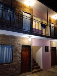 a building with a staircase and a balcony at La Casa Rosa Guanajuato in Guanajuato