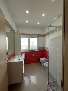 a bathroom with a toilet and a sink and a shower at Casa vacanza Helios in Leonforte