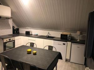 a kitchen with a table with yellow bowls on it at Le Montôbuis in Couvin