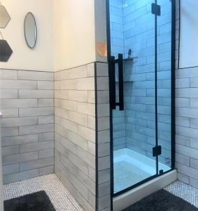 a shower with a glass door in a bathroom at Two level, 2-Bedrm, 1 ½ Bathrm. in Seaside Heights