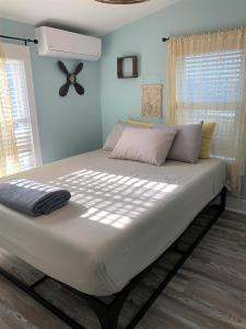 a large bed in a bedroom with blue walls at Two level, 2-Bedrm, 1 ½ Bathrm. in Seaside Heights