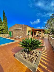 a villa with a swimming pool and a house at Finca Ses Barraques in Manacor