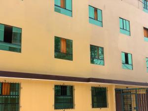 a facade of a building with barred windows at Hostal Residencial La Esmeralda in Lima