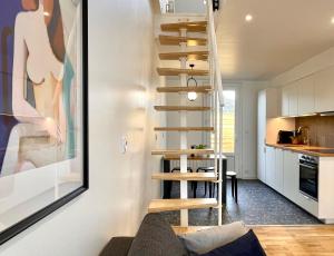 a spiral staircase in a living room next to a kitchen at Appartement dans une maison cosy in Chartres