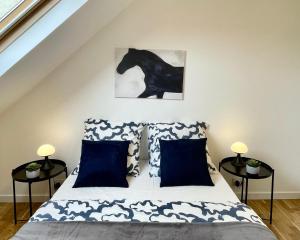 a bedroom with a bed with a black horse on the wall at Appartement dans une maison cosy in Chartres
