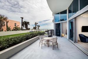 a patio with a table and chairs on a building at Max Beach Resort in Daytona Beach