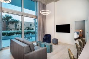 a living room with a couch and a television at Max Beach Resort in Daytona Beach