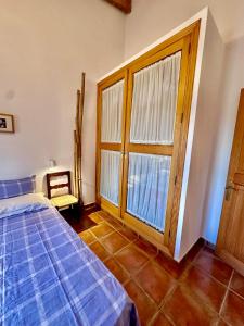 a bedroom with a bed and a large window at Finca Ses Barraques in Manacor +13 photos