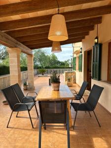 a patio with a wooden table and chairs at Finca Ses Barraques in Manacor