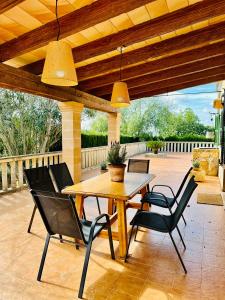 a wooden table and chairs on a patio at Finca Ses Barraques in Manacor