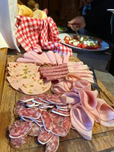 a bunch of different types of meats on a table at Pension DORFPLATZL Pitztal in Plangeross
