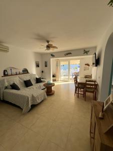 a living room with a bed and a table and chairs at Tramontana Villa in Cala'n Porter