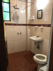a bathroom with a toilet and a sink at Luna in Taxco de Alarcón
