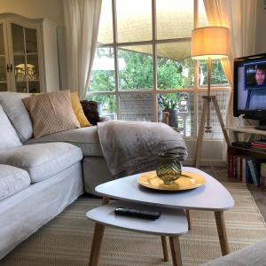 a living room with a couch and a table at Chalet 2Relax in Zutendaal