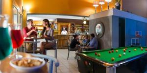 a group of people sitting at a bar with a pool table at Mobilhome 5 étoiles - Parc aquatique - eeiaid in Pénestin