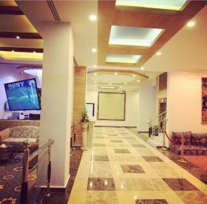 a large lobby with a room with a projection screen at بنان فال للشقق المخدومة in Hafr Al Baten