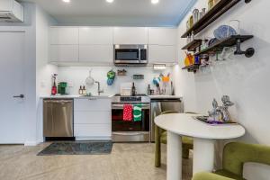 a small kitchen with a table and a counter top at Pet-Friendly Sacramento Studio Rental in Sacramento
