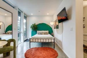a bedroom with a bed with a green headboard at Pet-Friendly Sacramento Studio Rental in Sacramento