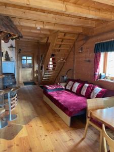 a living room with a couch in a wooden room at Haus Hanna in Wolfsberg
