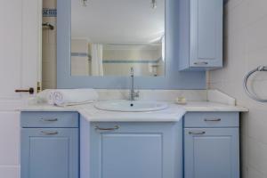 a bathroom with a blue sink and a mirror at Villa la vue in Ano Syros +36 photos