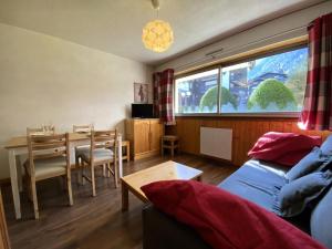 ein Wohnzimmer mit einem Tisch und einem Esszimmer in der Unterkunft Résidence Clos Du Savoy - Studio pour 4 Personnes 964 in Chamonix-Mont-Blanc