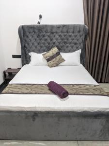 - un lit avec une grande tête de lit et des oreillers gris dans l'établissement Mount Top Chalet, à Tangalle
