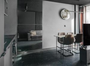 a kitchen with a table and chairs in a room at BLACKNIGHT Apartment - Self Check-In 24h in Wrocław