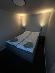 a bedroom with a bed with two towels on it at Your home away from home, apartment 1 in Tromsø