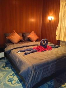 a bed with a heart made out of towels on it at SK Hometel Samui Airport in Bang Rak Beach
