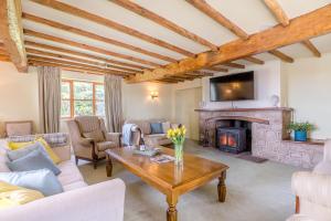 a living room with a couch and a fireplace at The Chestnuts in Tenbury
