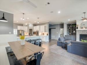 a kitchen and living room with a table and a couch at Clearview Castle - Pool* Jacuzzi Lake View in Lewisville