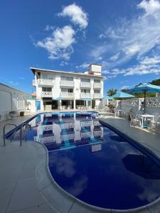 a hotel with a pool in front of a building at Juan de la vega in La Vega