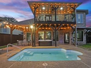 a house with a swimming pool in the yard at Clearview Castle - Pool* Jacuzzi Lake View in Lewisville