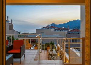 a balcony with a view of the ocean and mountains at Sand Lily in Plakias