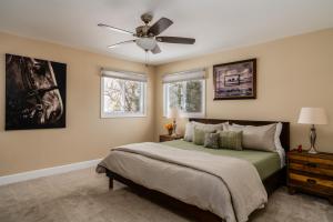 a bedroom with a bed and a ceiling fan at Gallatin Gateway Getaway in Bozeman