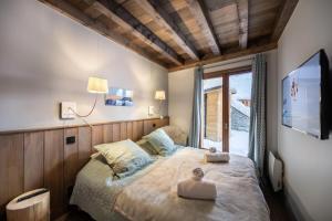 a bedroom with a bed with two towels on it at Résidence Prosper - Chalets pour 12 Personnes 154 in Courchevel