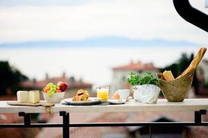a table with food and drinks on top of it at Eselböck Villa Valter - Historic seaside House in Lovran in Lovran