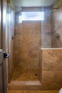 a shower with a glass door in a bathroom at Elkhorn Sun Valley & Dollar Mountain Adventures in Sun Valley