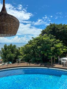 a swimming pool with a view of the ocean at Pousada La Belle Maison Brigitte Bardot in Búzios